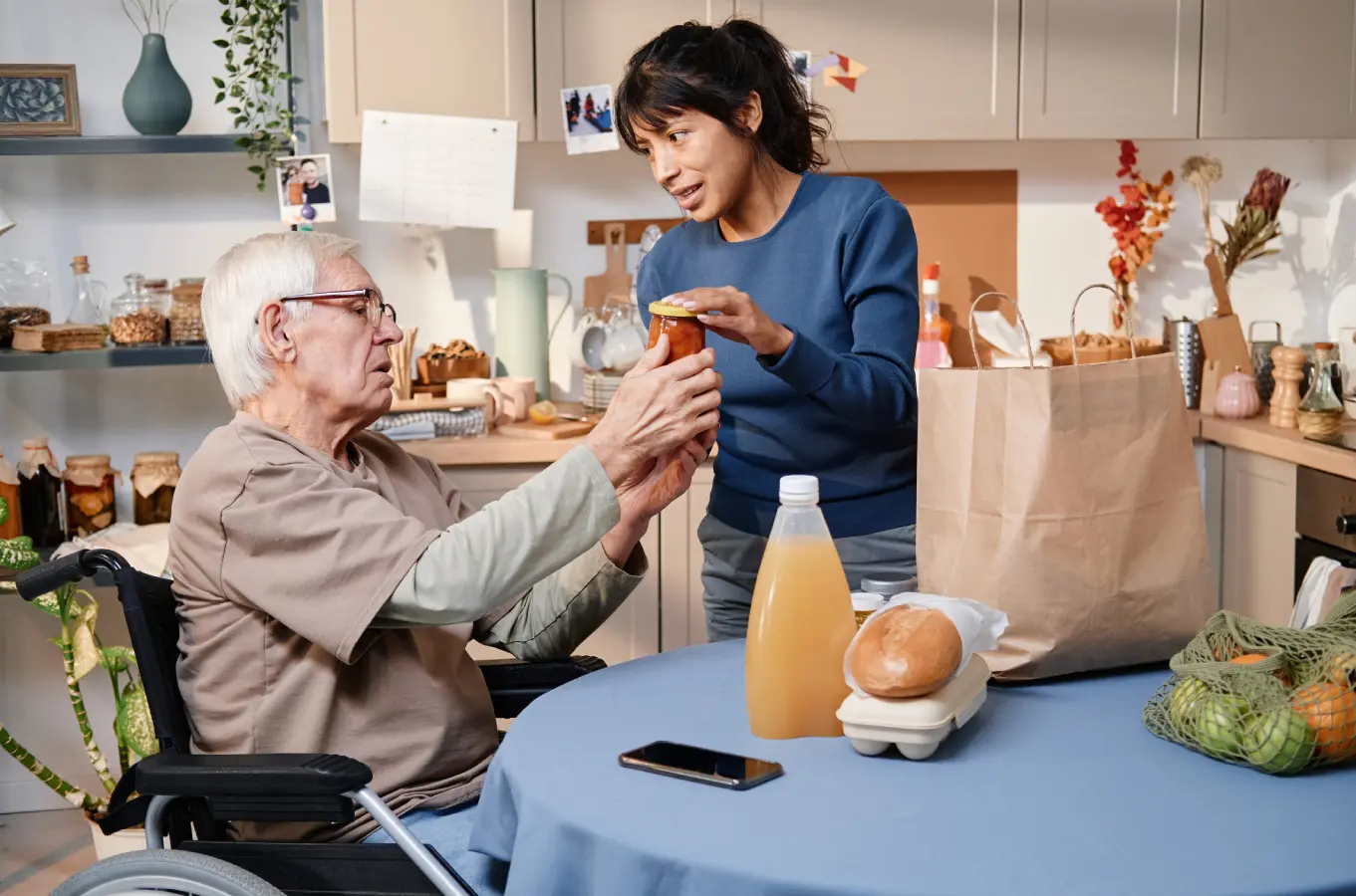 blog111 A woman is giving an elderly man some food.