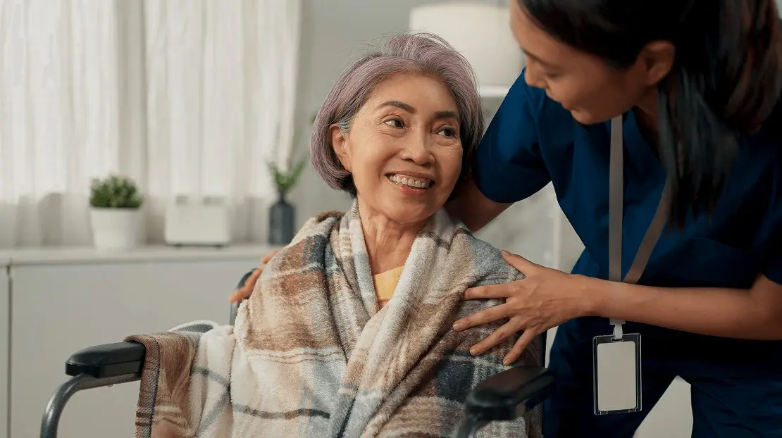 h3 (1) A woman is wrapped in a blanket and smiling.